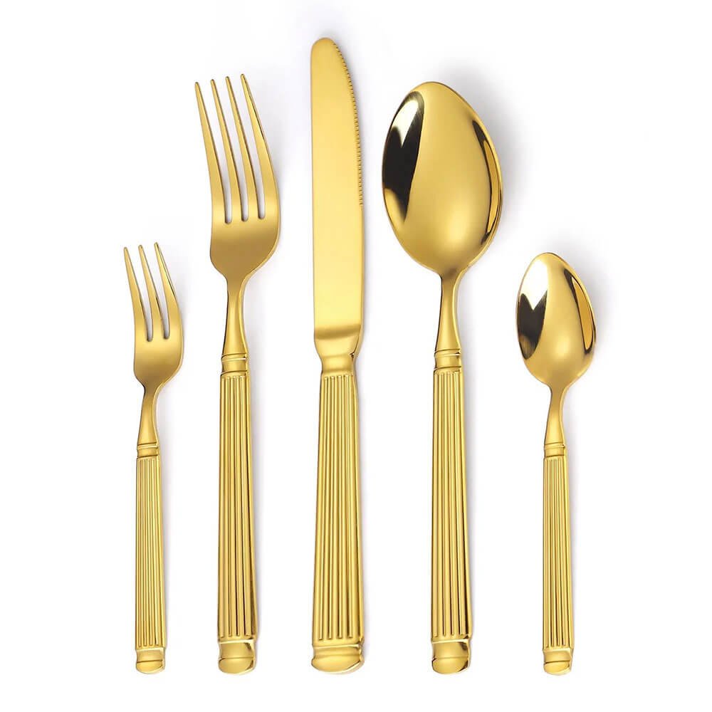 Gold flatware set with grooved handles, includes dinner fork, salad fork, knife, tablespoon, and teaspoon, arranged vertically.