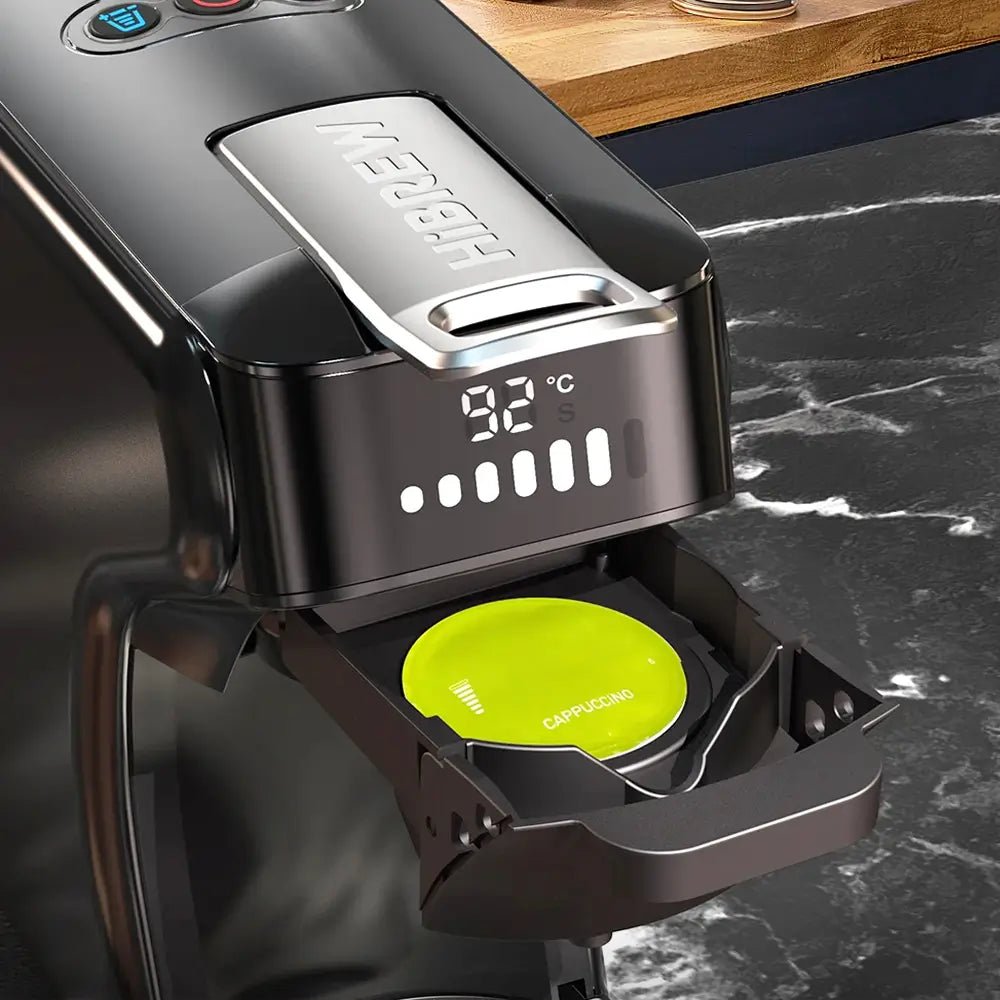 Coffee machine with a digital display and green cap on a marble countertop.