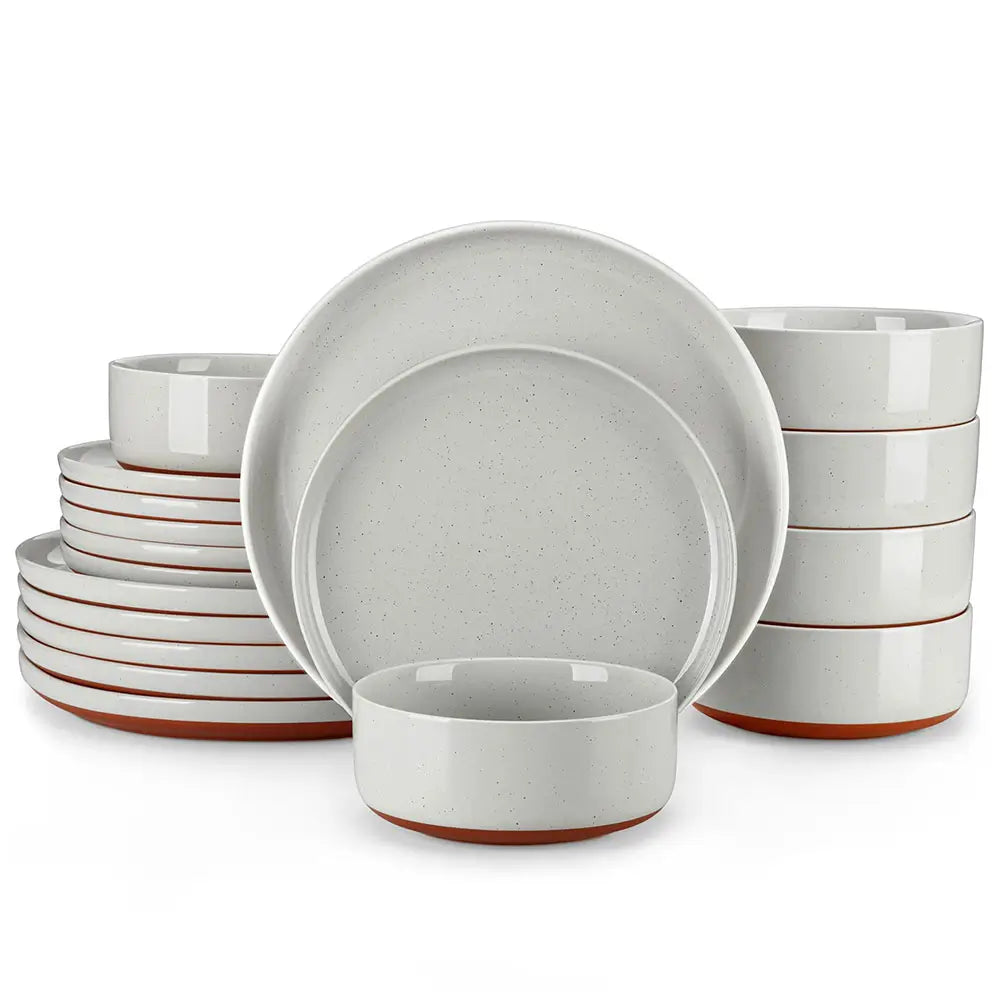 Set of white stoneware dinnerware with brown accents on a white background