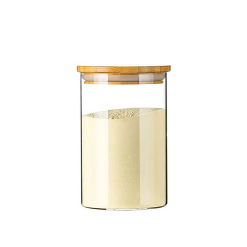 A clear cylindrical glass and bamboo spice jar filled with a light-colored powder, featuring a flat bamboo lid with a silicone gasket for an airtight seal.