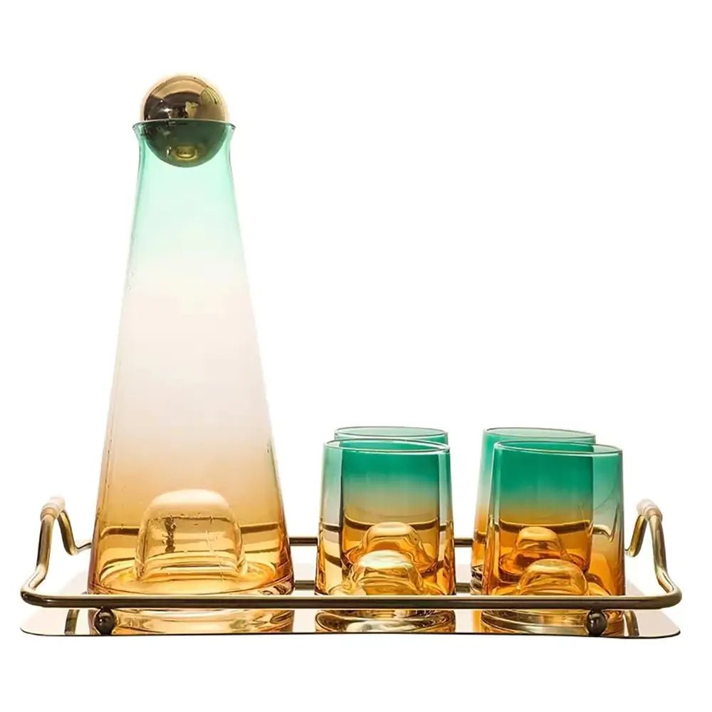 Glass carafe set with a gradient green and amber carafe, gold ball lid, four matching glasses, and a gold tray.