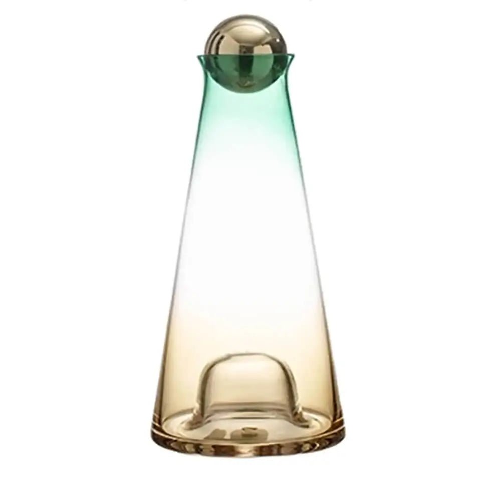 Glass carafe with a gold spherical lid, featuring a green-to-amber gradient design, displayed against a clean white background.