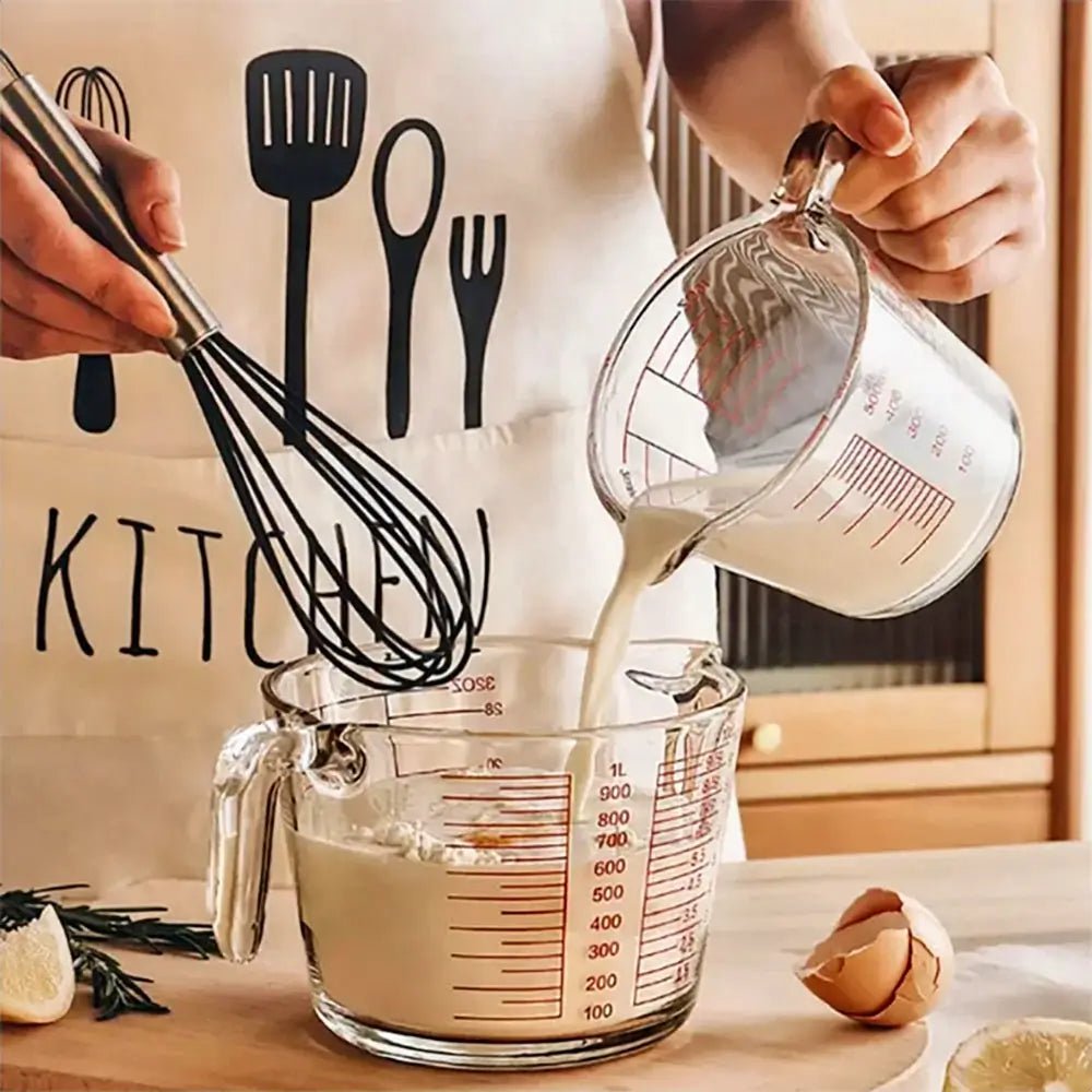 Person pouring batter into a glass measuring cup while whisking, using precise measurements for reliable cooking and baking.