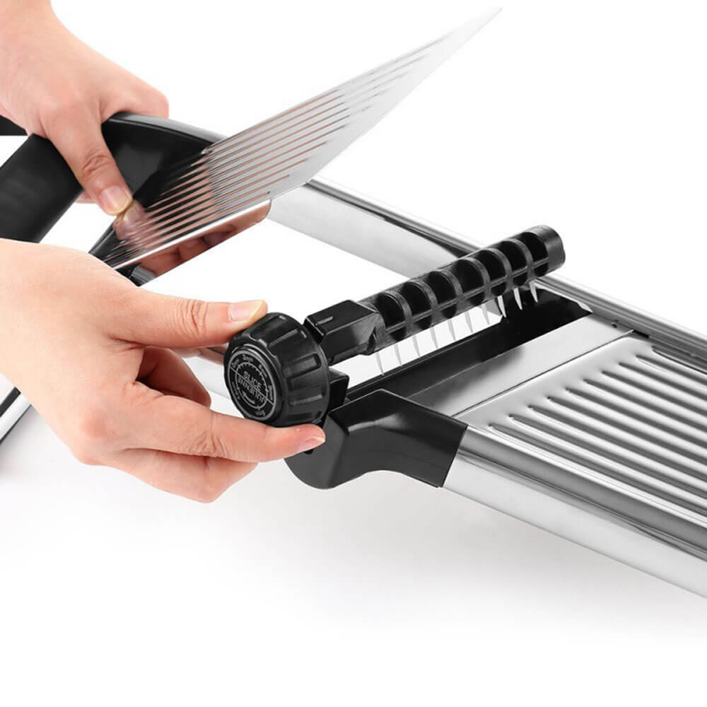 Kitchen utensils mandoline slicer showing adjustable blade setup and thickness control knob for precise slicing.