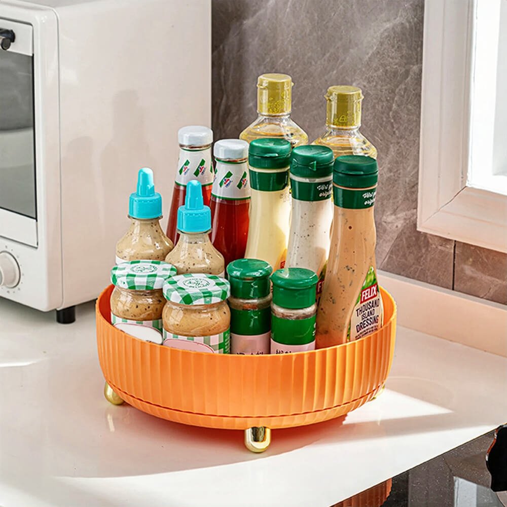 Lazy susan cabinet organizer holding bottles, sauces, and condiments neatly on the kitchen countertop for organized storage.