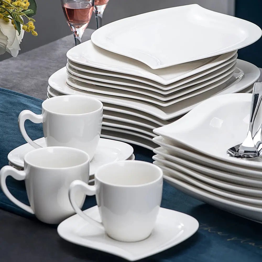Lightweight everyday dinnerware with stacked white plates, white cups, and matching white saucers.