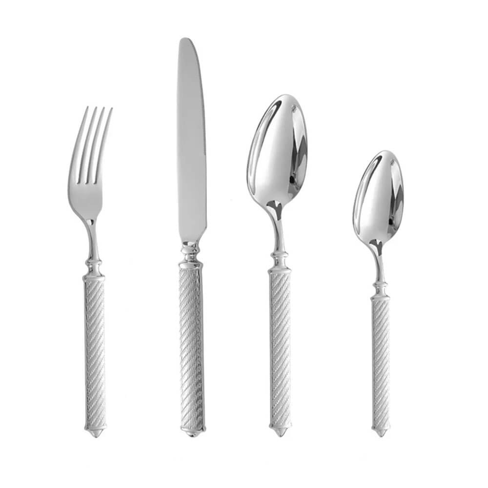 A sleek and elegant stainless steel cutlery set featuring a knife, fork, tablespoon, and teaspoon. Each piece has a polished silver finish with intricately textured handles, offering a refined and modern look. The set is displayed against a plain white background, highlighting its sophisticated design and craftsmanship.
