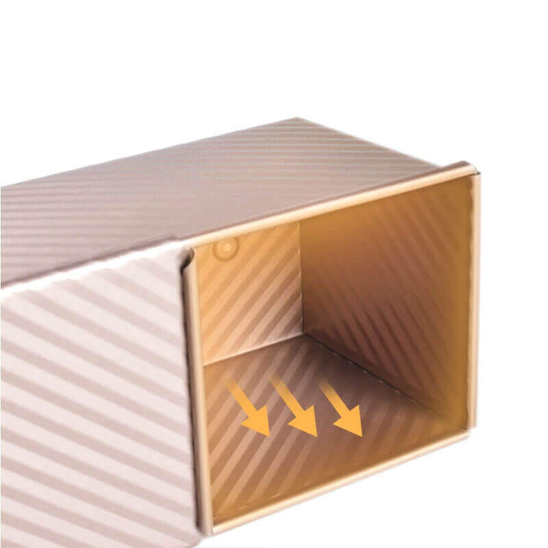 Interior view of a non-stick bread loaf pan with textured diagonal ridges and directional arrows highlighting airflow or release.
