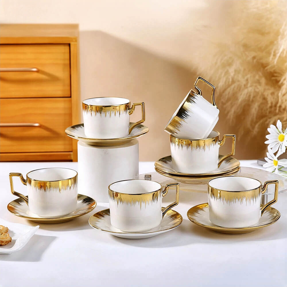 Porcelain tea cups and saucers sets featuring white and gold elegant design, perfect for luxury tea serving and upscale table settings.