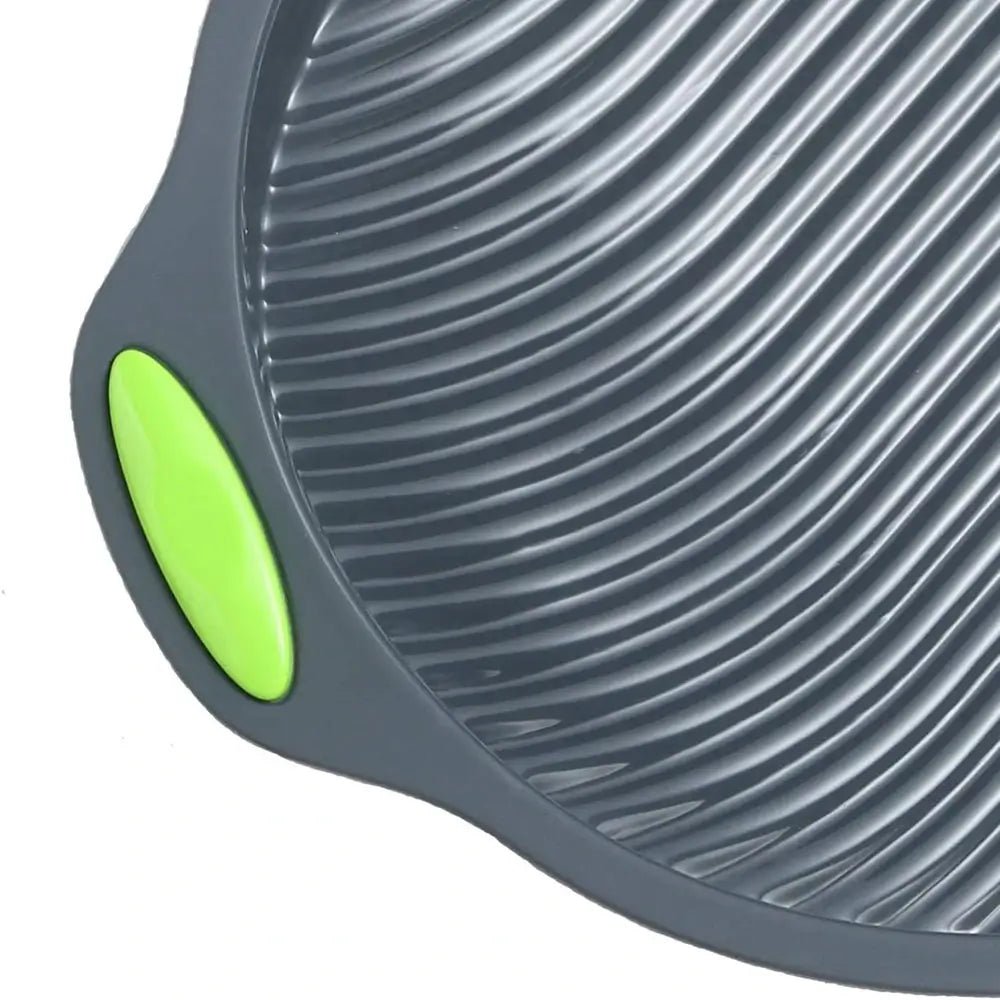 Close-up of a gray and green kitchen tool with textured surface