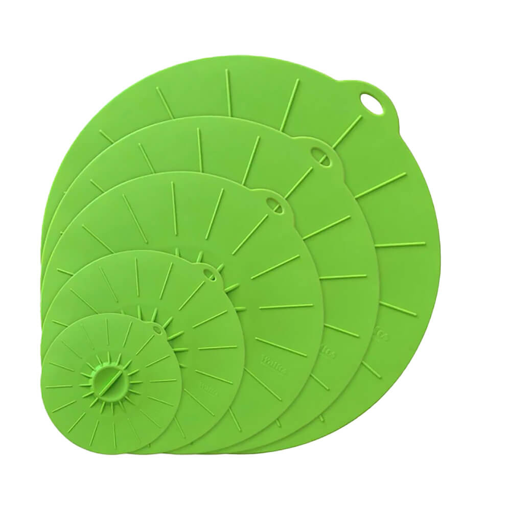 Green silicone cover lids in a set of five stackable sizes for sealing pots, pans, and containers.