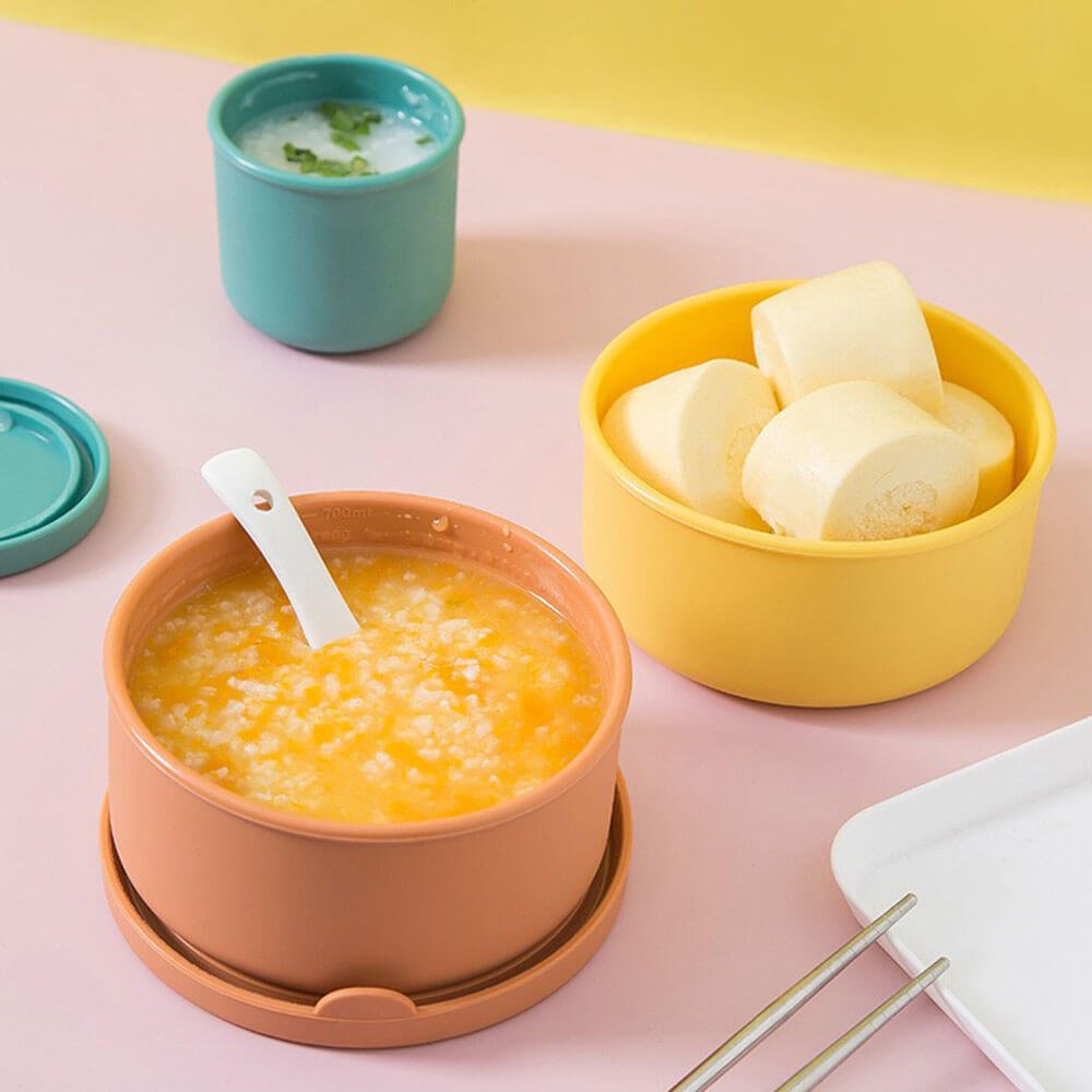 Colorful silicone food containers filled with porridge and snacks, ideal for safe, reusable storage and serving of hot or cold meals.