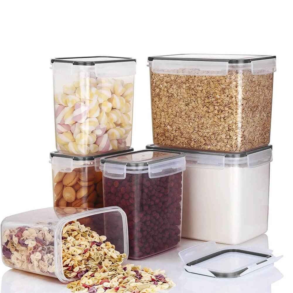 Clear stackable food storage containers for pantry holding oats, pasta, candy, flour, cookies, and dried berries.