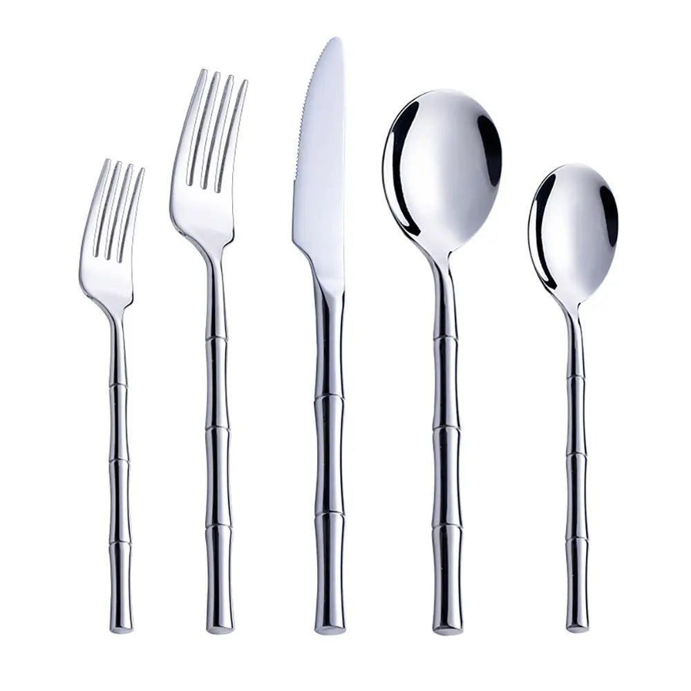 Close-up of 18/10 stainless steel silverware set with polished finish and intricate leaf-patterned handles.