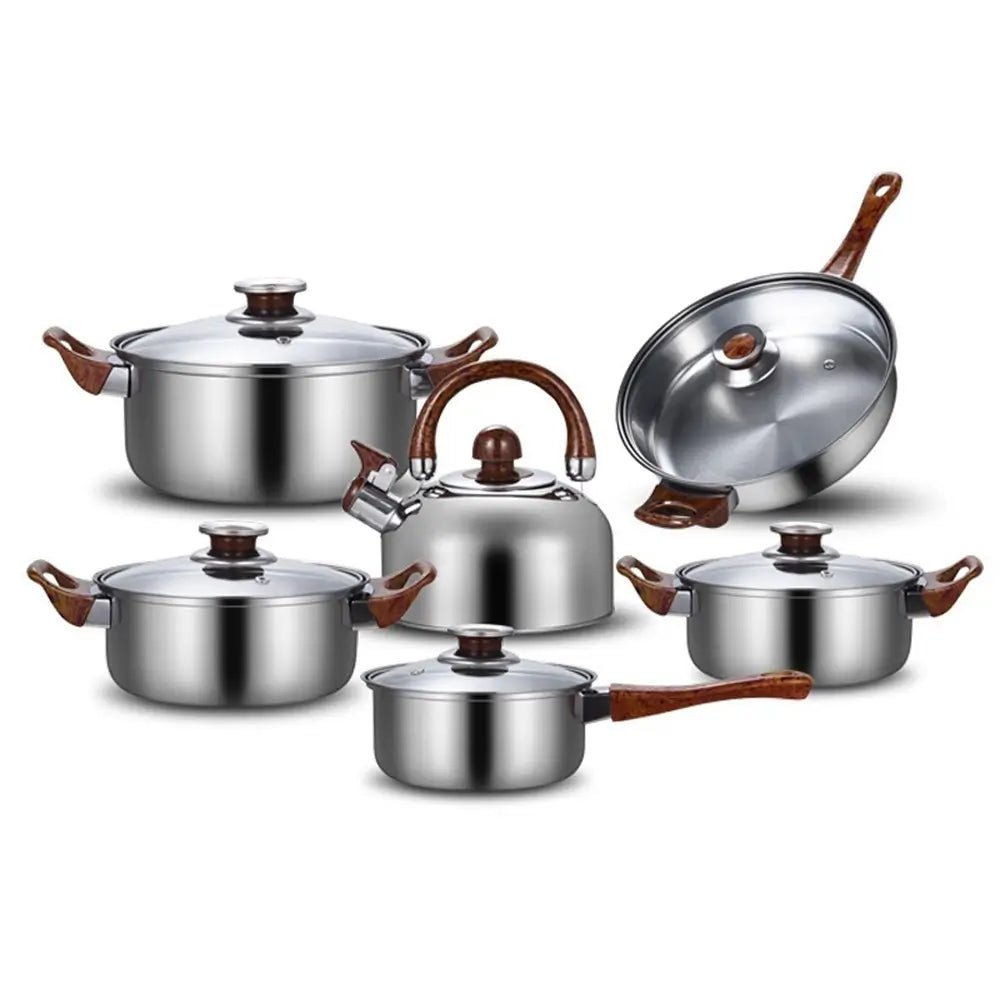 Set of stainless steel cookware with wooden handles on a white background
