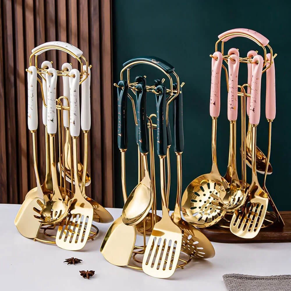 Three stainless-steel kitchen utensil sets with gold finishes and colorful marble-style handles in white, green, and pink.