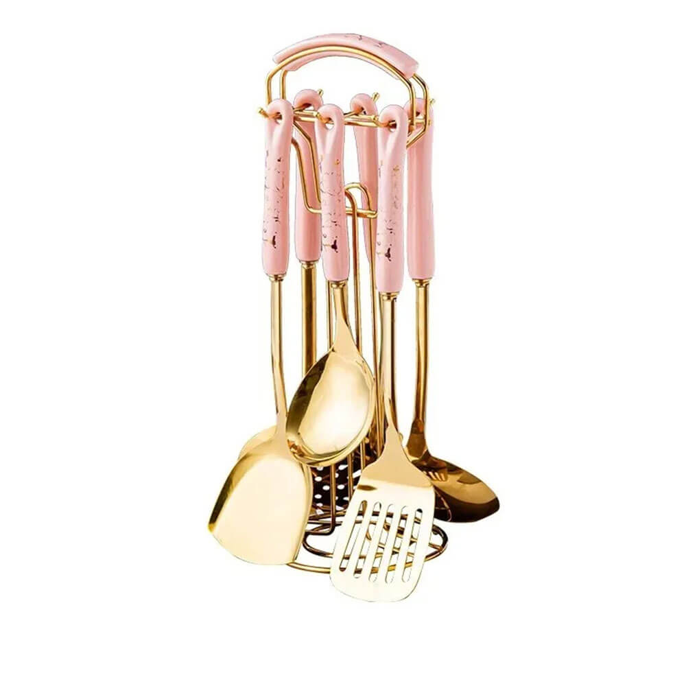 Gold stainless steel kitchen utensil set with pink marble handles, neatly hanging on a matching pink and gold stand.