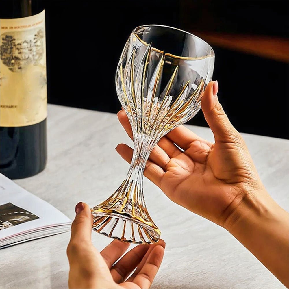 Elegant stemless cocktail glass with gold detailing, held in hand, perfect for wine, cocktails, and luxury home bar setups.