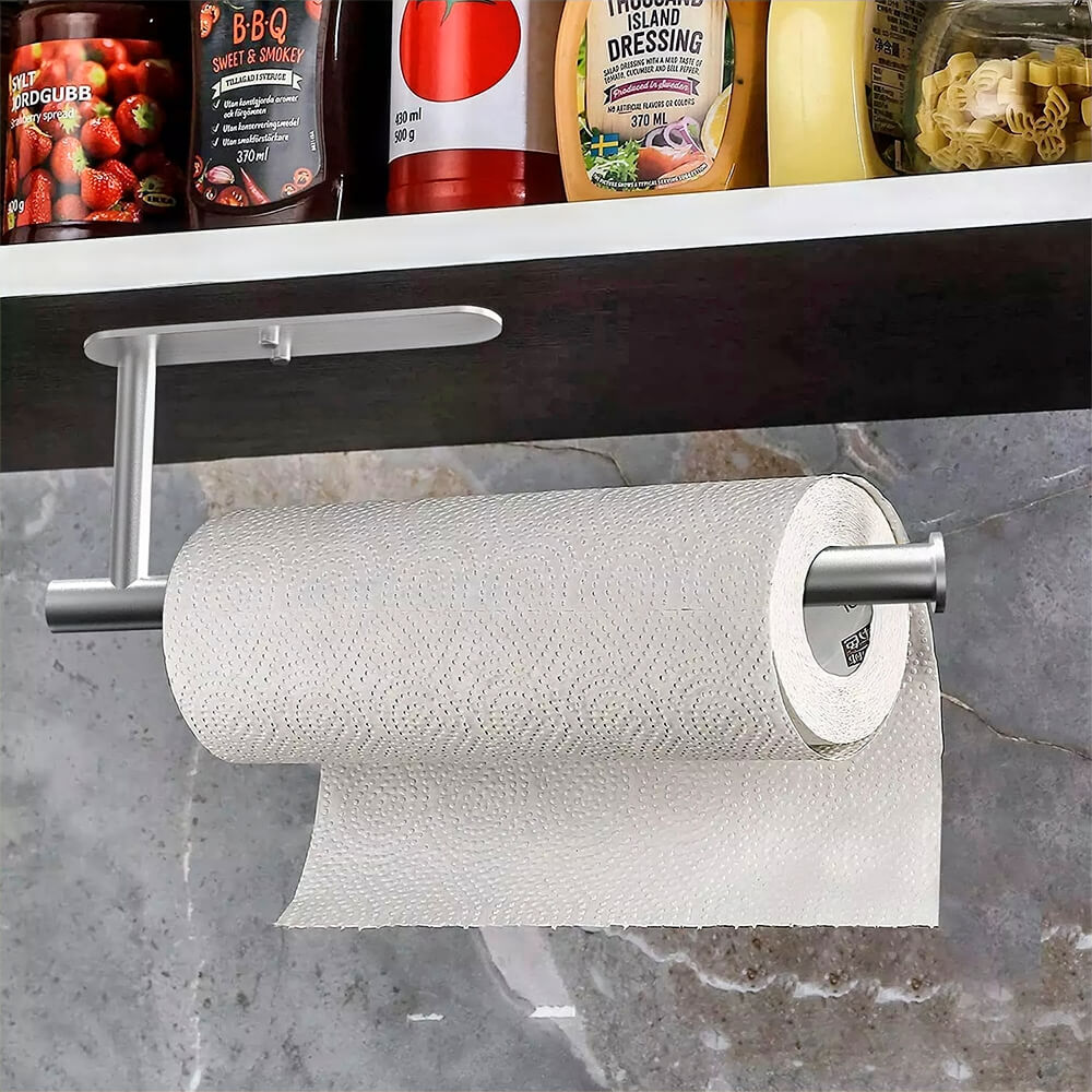 Under counter paper towel holder installed below kitchen shelf for convenient roll access and space saving organization.