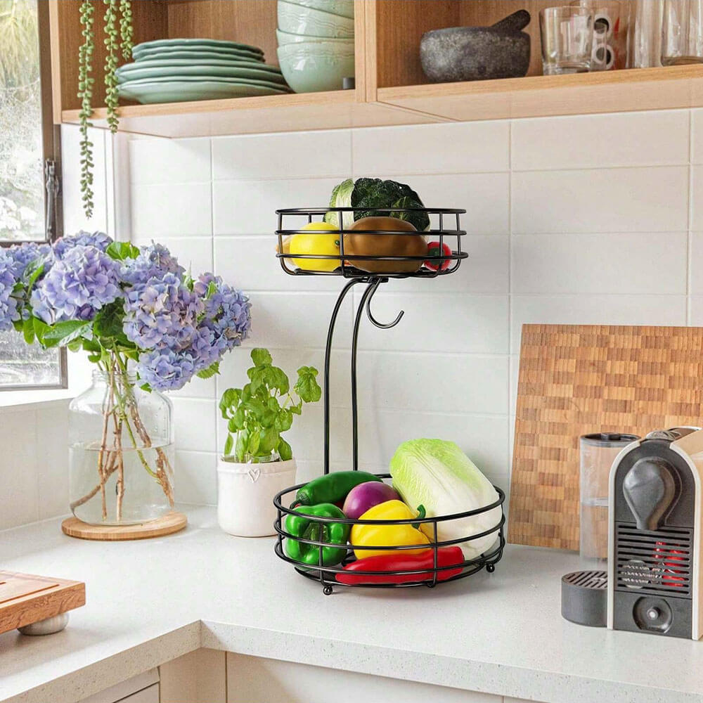 2-tier wire fruit basket on kitchen counter filled with vegetables and fruits.