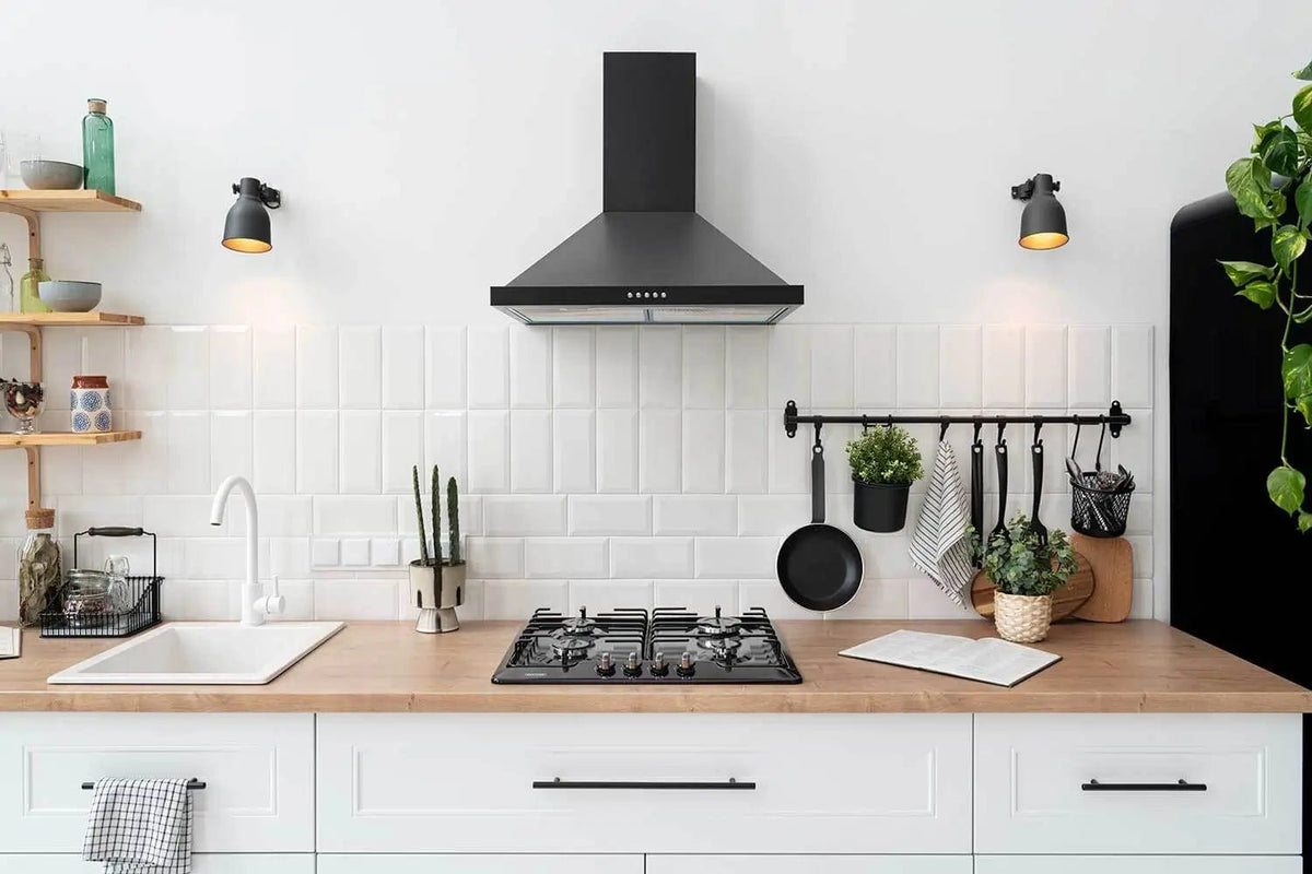 Modern white kitchen with wooden countertops, a gas stove, hanging utensils, and organized shelves — perfect setup for applying everyday cooking tips.