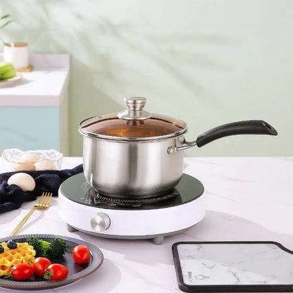 16cm stainless steel saucepan with lid on an electric cooktop, glass lid and black handle, shown in a kitchen setting.