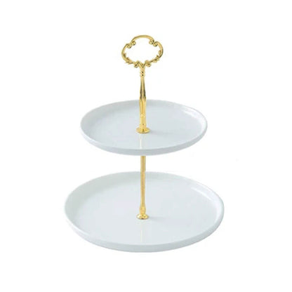 A beautiful 2-tier ceramic server with sleek white plates and a luxurious gold-tone stand. The tiers are perfectly sized to showcase appetizers, desserts, or snacks while adding elegance to any occasion. The decorative handle at the top provides easy portability, making it both stylish and functional.