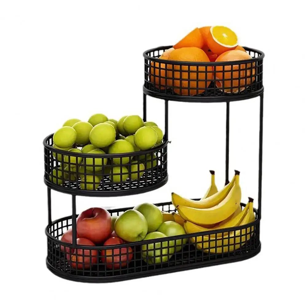 Black three-tier fruit basket with apples, bananas, and oranges on a white background.