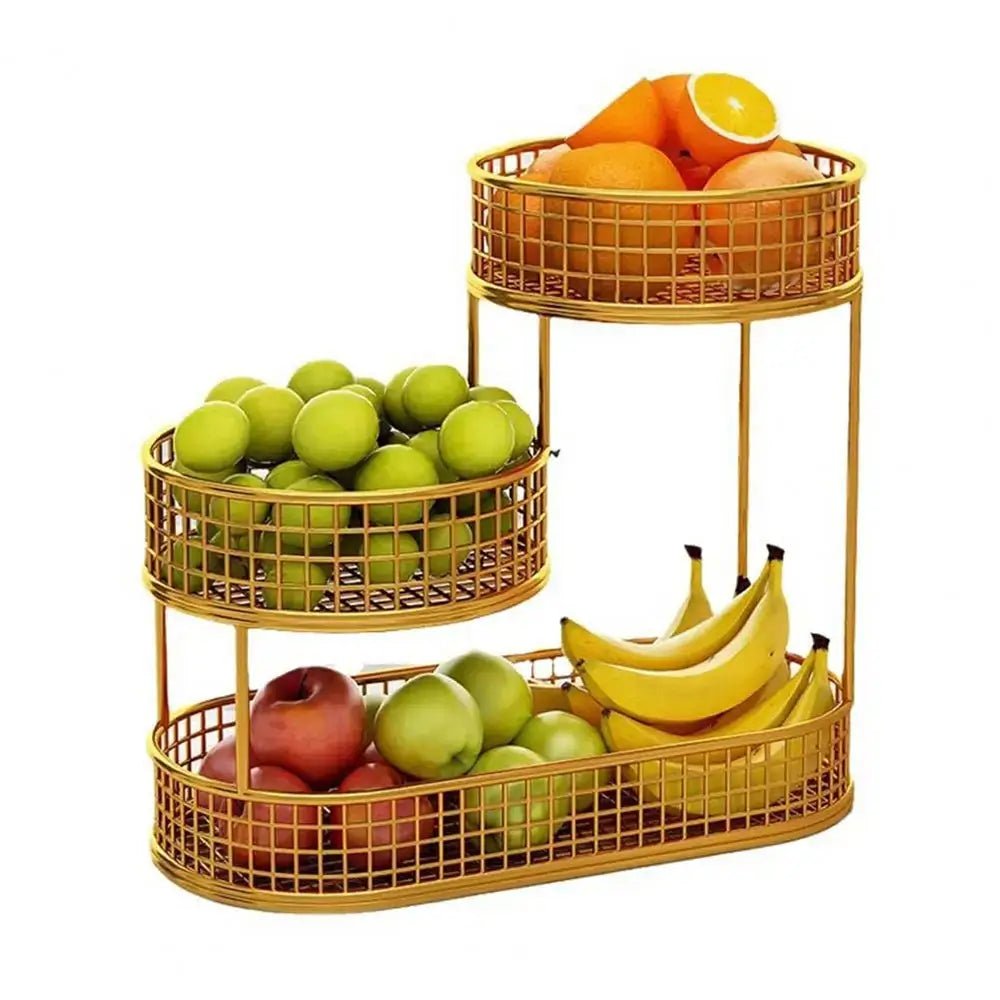 Gold 3 tier fruit basket holding oranges, green apples, red apples, and bananas arranged on three wire mesh tiers.