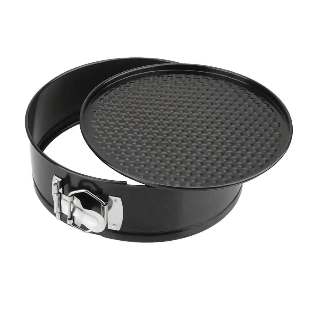 Black springform pan with textured base on a white background.