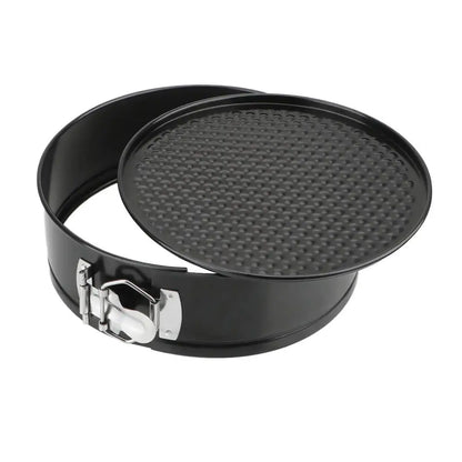 Black springform pan with textured base on a white background.