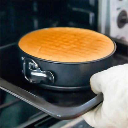 Person wearing a white glove removing a baked dish from an oven.
