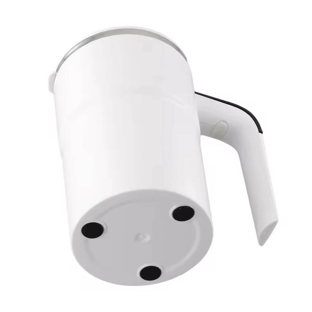 A white automatic coffee mug is shown from the bottom, highlighting its anti-slip base with three black grip pads. The handle, designed for ergonomic use, features a sleek black edge and modern styling. The overall design is minimalist and functional.