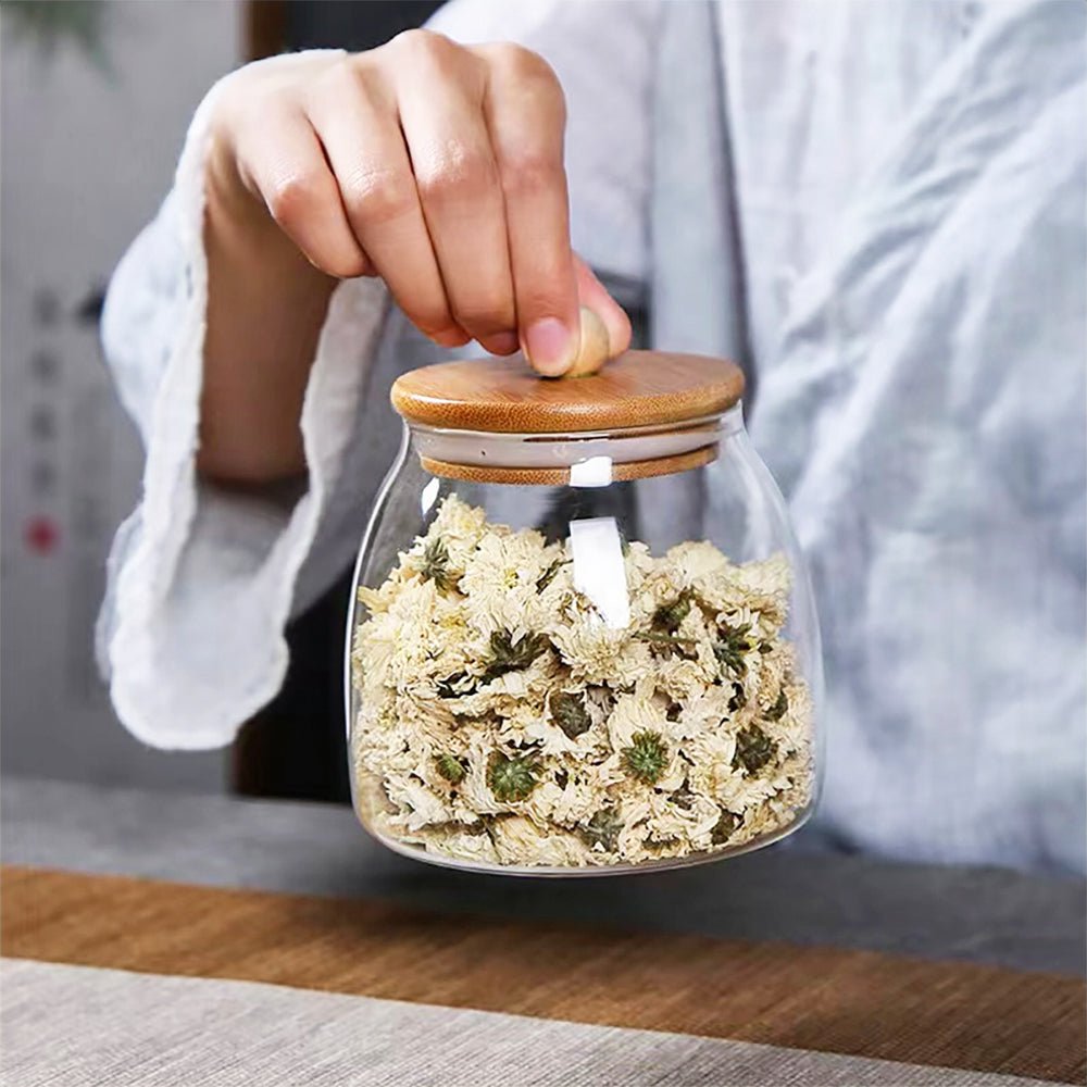 Bamboo and glass jars with airtight lids, ideal for eco-friendly kitchen storage solutions.