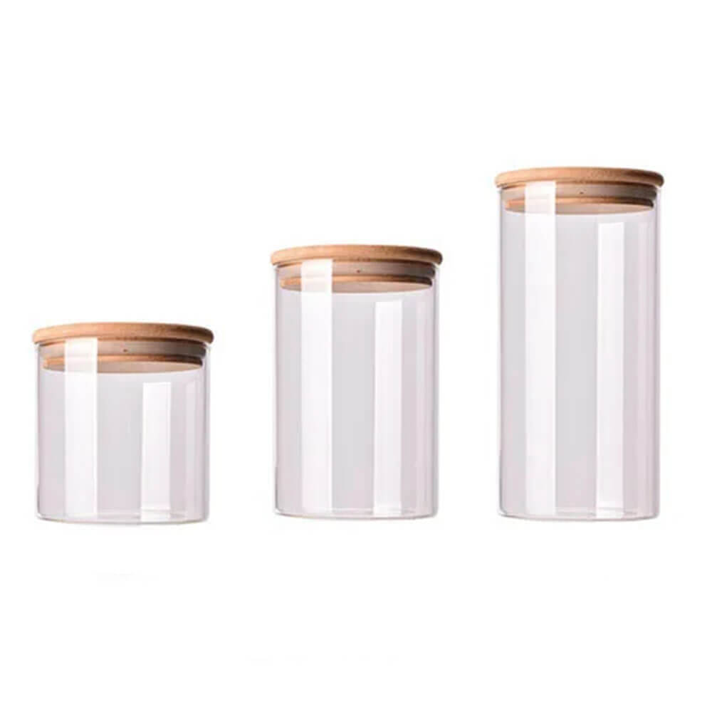 Three clear cylindrical bamboo and glass spice jars in small, medium, and large sizes, each with a natural bamboo lid and silicone seal.