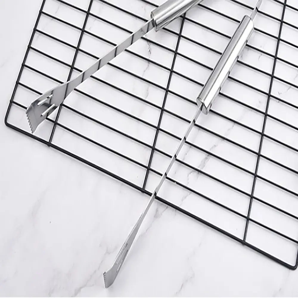 Metal cooling rack with tongs on a marble surface.