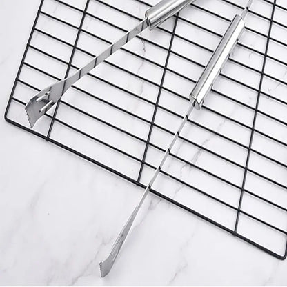 Metal cooling rack with tongs on a marble surface.
