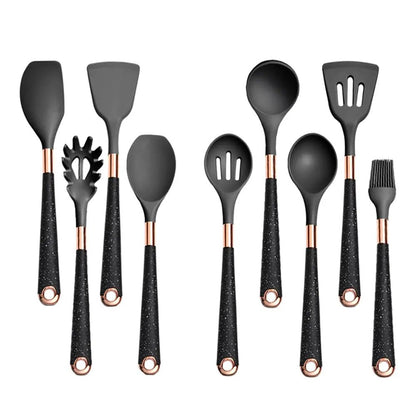 A 10-piece black silicone kitchen utensil set with rose gold accents and speckled black handles, neatly arranged upright.