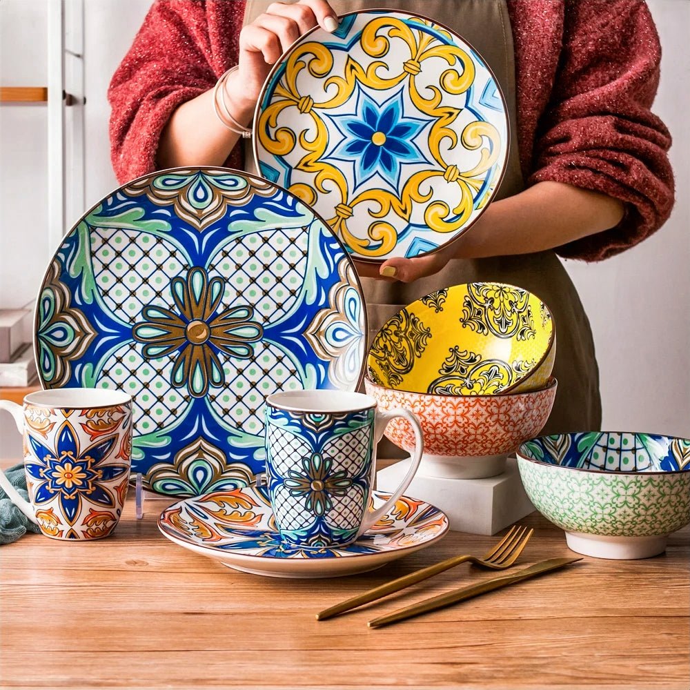 A woman is holding a plate in front of a beautifully arranged table with dinner plates, salad plates, mugs, and cereal bowls from the best dinnerware sets.