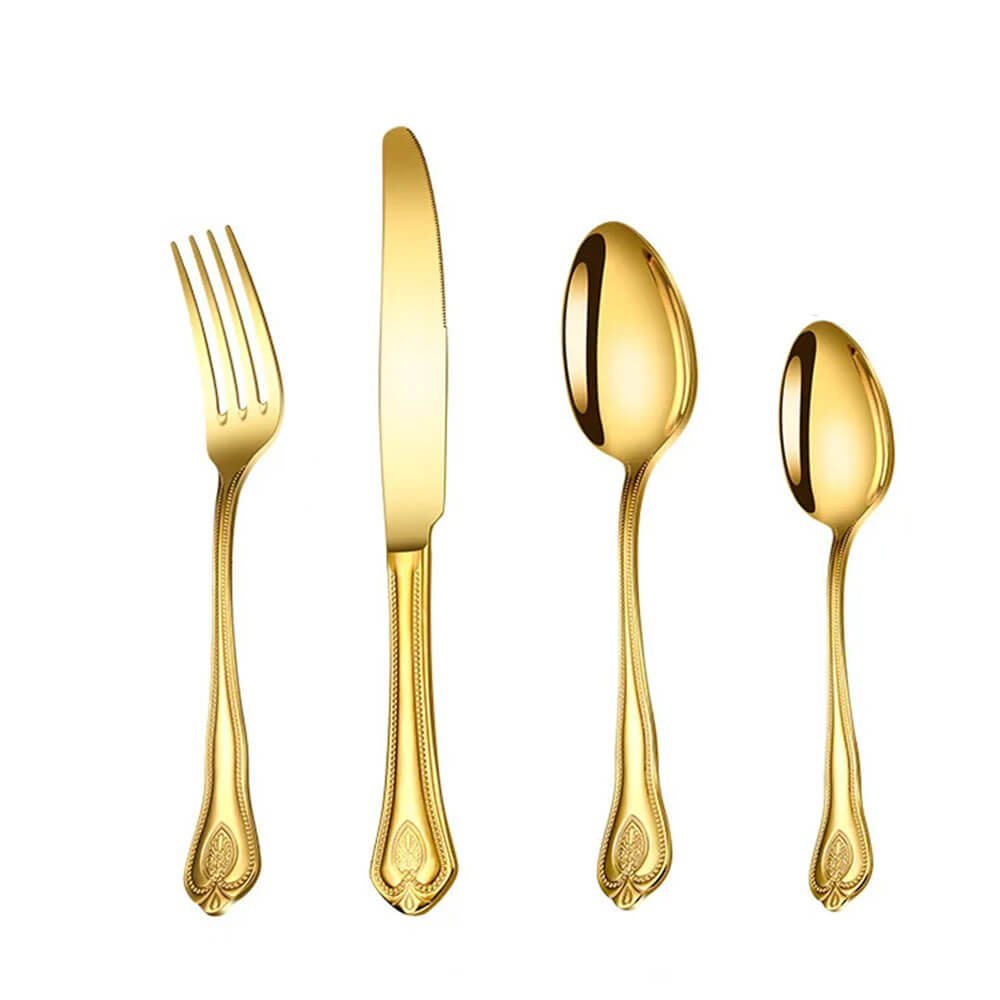 A gold flatware set displayed on a white background, consisting of a fork, knife, tablespoon, and teaspoon. Each piece features a sleek, reflective gold finish and ornate handle detailing with bead-like patterns and floral motifs. 