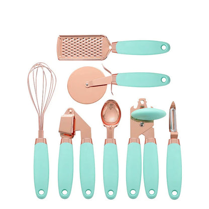 A stylish best kitchen tools set featuring rose gold utensils with mint green ergonomic handles, including a whisk, grater, pizza cutter, garlic press, ice cream scoop, can opener, and peeler.