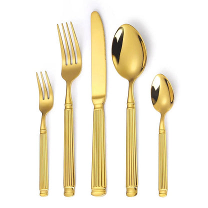 Gold flatware set with grooved handles, includes dinner fork, salad fork, knife, tablespoon, and teaspoon, arranged vertically.
