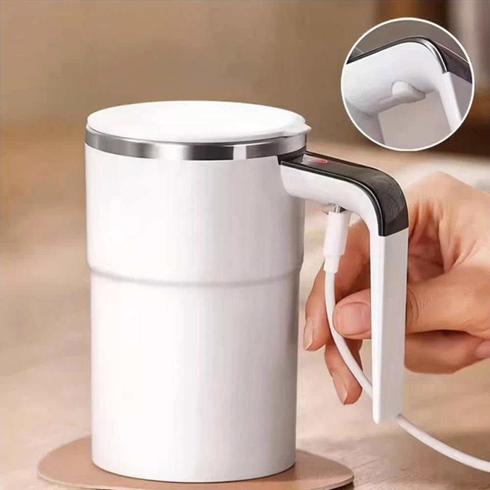 A white self-stirring mug with a sleek stainless steel rim is shown in use. The mug features a Type-C charging port integrated into the handle for convenient recharging. The inset image highlights a close-up of the charging port. The design is modern and practical, ideal for everyday use.