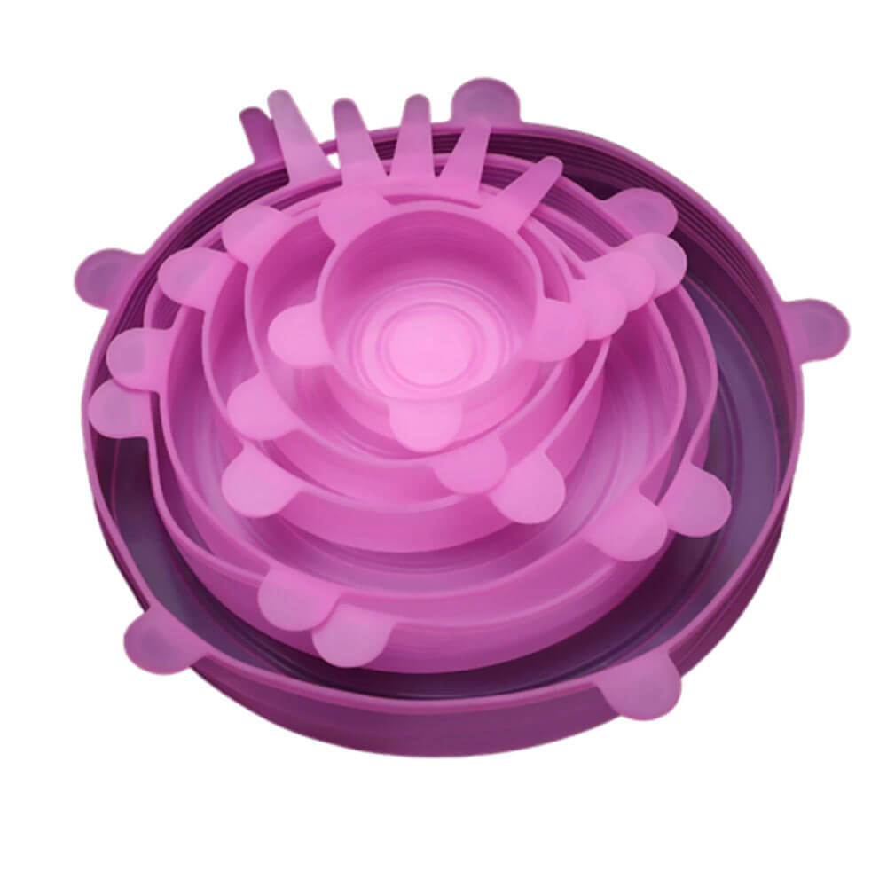Set of pink silicone stretch lids in multiple sizes, neatly stacked inside one another, each lid featuring pull tabs for easy stretching and sealing.