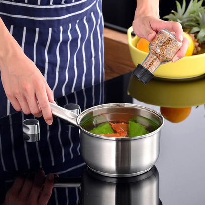 Person seasoning a dish in a sleek stainless steel saucepan on a modern stovetop, highlighting a premium option from the best stainless steel cookware sets.