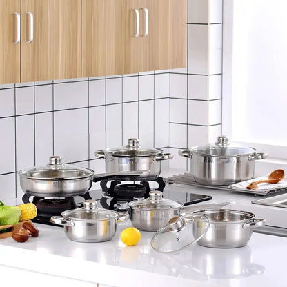 best stainless steel cookware sets with pots, pans, and glass lids arranged on a modern kitchen countertop and stovetop