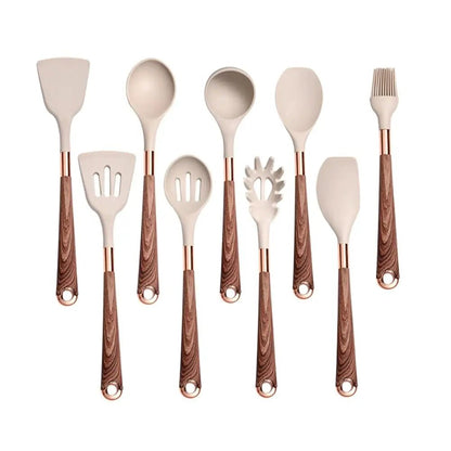 Set of 9 cooking utensils for non stick pans with beige silicone heads and wood pattern handles, neatly arranged on a white background