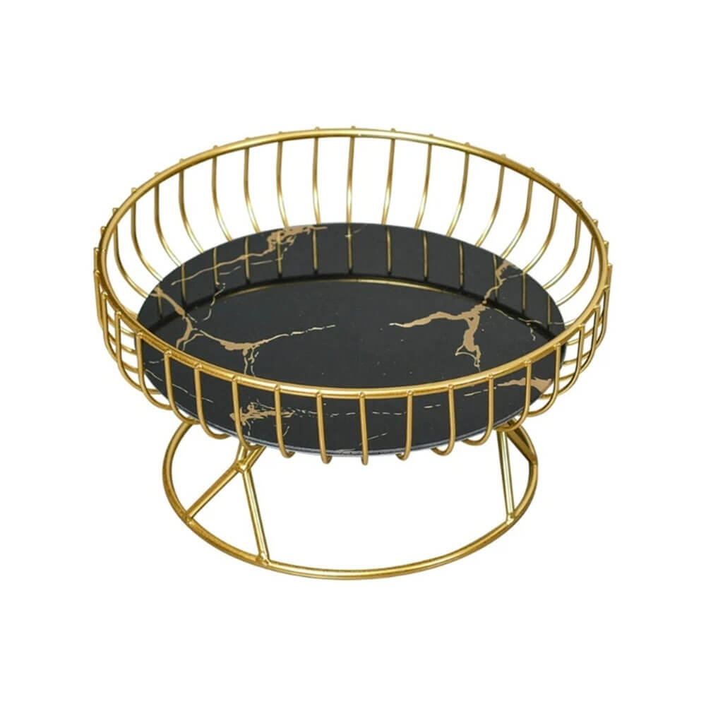 A stylish black pedestal fruit bowl featuring a sleek round black marble base with gold vein detailing and a surrounding gold metal wire frame for a modern and elegant design.