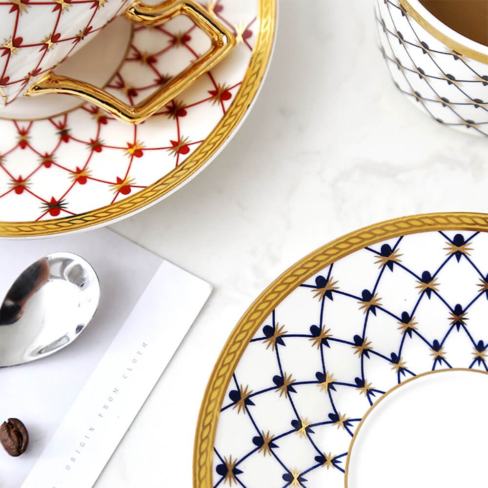 A close-up of the honeycomb tea set featuring intricate patterns on the saucers and a blue tea cup. The design highlights blue and red honeycomb motifs with golden accents, showcasing the elegant craftsmanship of the set.