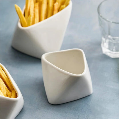 A bowl of French fries next to an empty ceramic bowl, highlighting a stylish serving option for snacks.